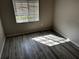 Bright bedroom with wood floors, natural light, and a window with views of the outdoors at 9606 Seadale Ct # 101, Riverview, FL 33578