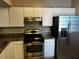 Kitchen featuring stainless steel appliances, white cabinets, and brown countertops at 9606 Seadale Ct # 101, Riverview, FL 33578