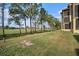 Landscaped backyard with grassy area and golf course view at 2400 Feather Sound Dr # 418, Clearwater, FL 33762