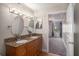 Bathroom with granite double vanity and oval mirrors at 2400 Feather Sound Dr # 418, Clearwater, FL 33762