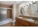 Bathroom with granite double vanity, shower, and tile flooring at 2400 Feather Sound Dr # 418, Clearwater, FL 33762