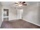 Carpeted bedroom with ceiling fan and access to bathroom at 2400 Feather Sound Dr # 418, Clearwater, FL 33762
