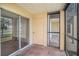 Screened porch with tile flooring and view of golf course at 2400 Feather Sound Dr # 418, Clearwater, FL 33762