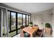 Sunroom with table and chairs, offering tranquil lake views at 2679 Sabal Springs Cir # 203, Clearwater, FL 33761