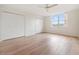 Bright bedroom with wood flooring, ceiling fan, and double closets at 2699 Seville Blvd # 403, Clearwater, FL 33764