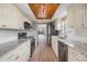 Modern kitchen with granite countertops, stainless steel appliances, and light wood cabinets at 2699 Seville Blvd # 403, Clearwater, FL 33764