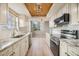 Modern kitchen with granite countertops, stainless steel appliances, and light wood cabinets at 2699 Seville Blvd # 403, Clearwater, FL 33764