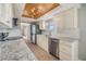 Modern kitchen with granite countertops, stainless steel appliances, and light wood cabinets at 2699 Seville Blvd # 403, Clearwater, FL 33764