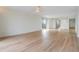 Spacious living room featuring light wood laminate flooring and a ceiling fan at 2699 Seville Blvd # 403, Clearwater, FL 33764