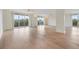 Spacious living room with light wood floors and access to a balcony at 2699 Seville Blvd # 403, Clearwater, FL 33764