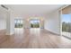 Bright living room featuring hardwood floors and large windows at 2699 Seville Blvd # 403, Clearwater, FL 33764