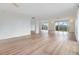 Open living area with hardwood floors and multiple windows at 2699 Seville Blvd # 403, Clearwater, FL 33764