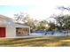 Community pool with lounge chairs and covered patio at 2699 Seville Blvd # 403, Clearwater, FL 33764