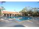Inviting community pool with surrounding lounge chairs at 2699 Seville Blvd # 403, Clearwater, FL 33764