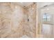 Updated shower with beige tile walls at 2699 Seville Blvd # 403, Clearwater, FL 33764