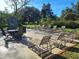 Relaxing pool deck with lounge chairs and patio tables at 3536 Countrybrook Ln # 13, Palm Harbor, FL 34684