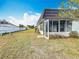 View of the backyard with a screened enclosure at 3932 Ashwood Ln # 42, Sarasota, FL 34232