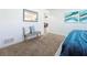 Bedroom with carpet, bench, and view into dining area at 3932 Ashwood Ln # 42, Sarasota, FL 34232