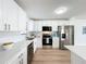 Bright kitchen featuring white cabinets and stainless steel appliances at 3932 Ashwood Ln # 42, Sarasota, FL 34232