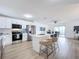 Modern kitchen with white cabinets, stainless steel appliances, and island at 3932 Ashwood Ln # 42, Sarasota, FL 34232