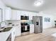 Renovated kitchen with white cabinets, stainless steel appliances, and quartz counters at 3932 Ashwood Ln # 42, Sarasota, FL 34232