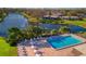 Community pool with lounge chairs and tables at 3932 Ashwood Ln # 42, Sarasota, FL 34232