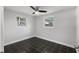 Well-lit bedroom featuring dark tile floors and ceiling fan at 4951 86Th N Ave, Pinellas Park, FL 33782