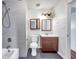 Bathroom with shower/tub, vanity, and tiled walls at 6948 Trout St, Tampa, FL 33617