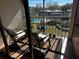 Relaxing balcony with rocking chairs, offering pool and landscape views at 8765 Bardmoor Blvd # 308, Seminole, FL 33777