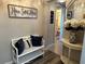 Bright and airy entryway with a white bench and access to bathroom at 8765 Bardmoor Blvd # 308, Seminole, FL 33777