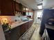 Updated kitchen featuring wood cabinets and tile countertops at 8765 Bardmoor Blvd # 308, Seminole, FL 33777