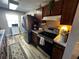 Modern kitchen with stainless steel appliances and wood cabinets at 8765 Bardmoor Blvd # 308, Seminole, FL 33777