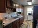 Bright kitchen with wood cabinets, tile backsplash, and stainless steel appliances at 8765 Bardmoor Blvd # 308, Seminole, FL 33777
