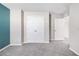 Bedroom with gray carpeting and a teal accent wall at 12930 Oak Hill Way, Parrish, FL 34219