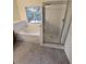 Bathroom with tub, shower, and gray tile floor at 12954 Fennway Ridge Dr, Riverview, FL 33579