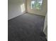 Spacious bedroom with grey carpet and window at 12954 Fennway Ridge Dr, Riverview, FL 33579