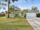 Charming single story home with a well manicured lawn and attached garage at 1611 Brook Dr, Dunedin, FL 34698