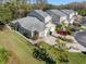 Aerial view of a well-maintained home with a driveway, manicured lawn, and established landscaping at 3203 Audubon Ct, Tarpon Springs, FL 34688