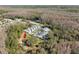 Scenic aerial view of townhomes surrounded by lush landscapes and a tranquil pond at 3203 Audubon Ct, Tarpon Springs, FL 34688