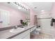 Well-lit bathroom with a shower, toilet, and wide vanity with a large mirror at 3203 Audubon Ct, Tarpon Springs, FL 34688