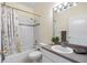 Clean bathroom featuring a shower-tub combo and modern vanity with a large mirror at 3203 Audubon Ct, Tarpon Springs, FL 34688