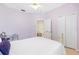 Inviting bedroom with tile floors, soft lavender walls, and a comfortable bed at 3203 Audubon Ct, Tarpon Springs, FL 34688