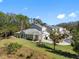 Tan house with a gray roof and lush lawn at 3203 Audubon Ct, Tarpon Springs, FL 34688