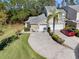 Charming home boasts well-manicured lawn, mature trees, and a spacious driveway leading to a multi-car garage at 3203 Audubon Ct, Tarpon Springs, FL 34688
