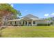 Charming one-story home featuring a manicured lawn, mature trees, and a welcoming front entrance at 3203 Audubon Ct, Tarpon Springs, FL 34688