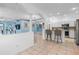 Open layout with bar stool seating, tile flooring, and stainless steel appliances at 3203 Audubon Ct, Tarpon Springs, FL 34688