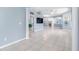 Spacious living room featuring tile floors, a ceiling fan, and decorative columns at 3203 Audubon Ct, Tarpon Springs, FL 34688