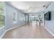 Light blue living room with tile floors and access to screened porch at 3203 Audubon Ct, Tarpon Springs, FL 34688