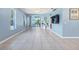 Spacious living room with tile flooring and access to a screened porch at 3203 Audubon Ct, Tarpon Springs, FL 34688