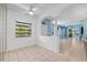 Bright living room with tile flooring, ceiling fan, and large windows offering natural light at 3203 Audubon Ct, Tarpon Springs, FL 34688